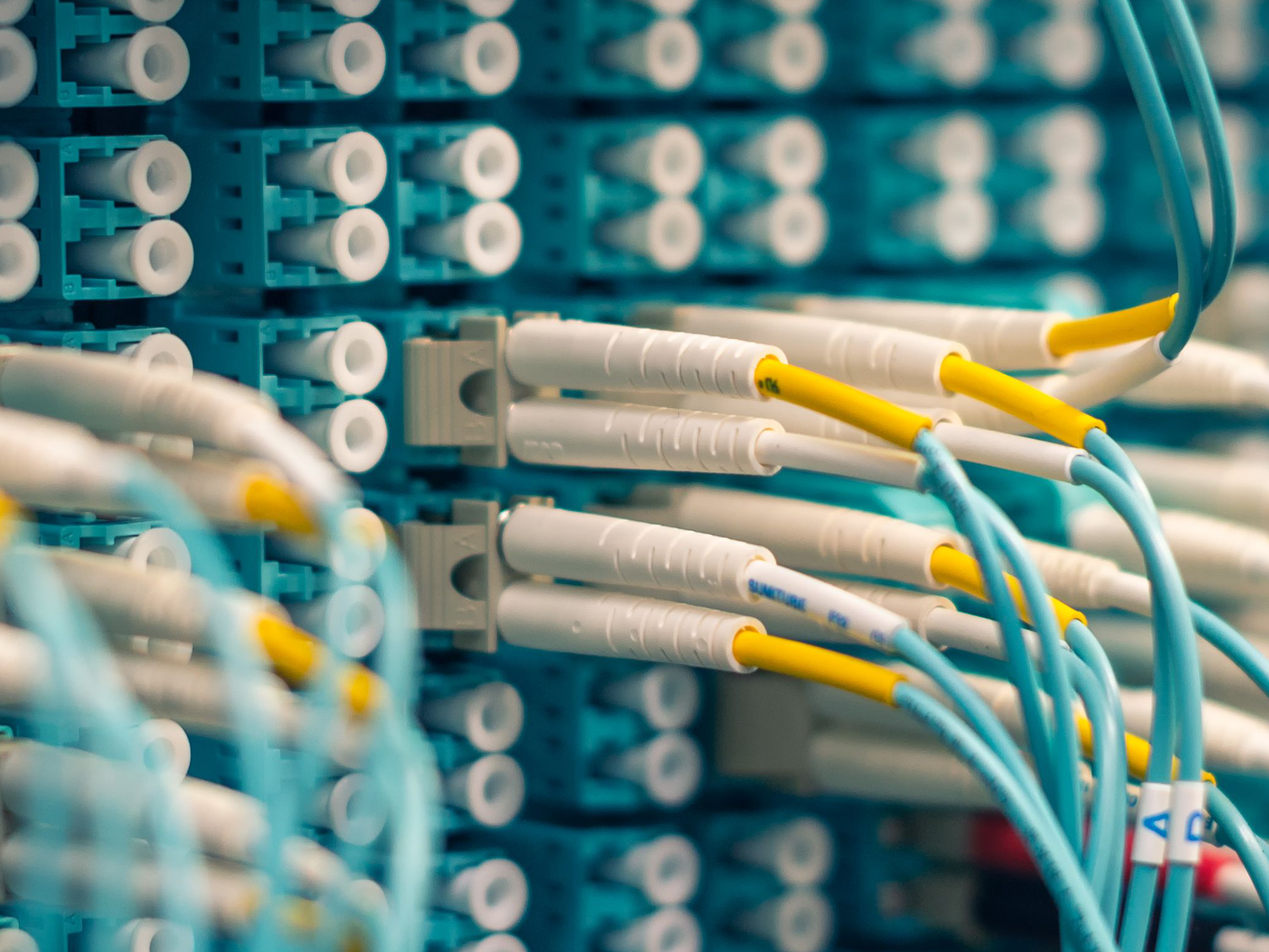 Neglected network racks with tangled, unmanaged cabling before remediation